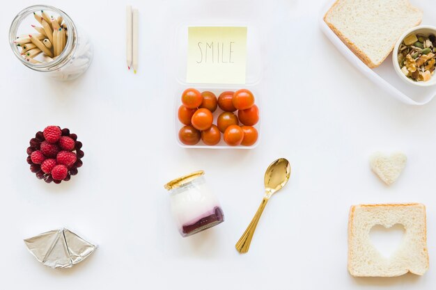 Pencils and cute note near healthy food