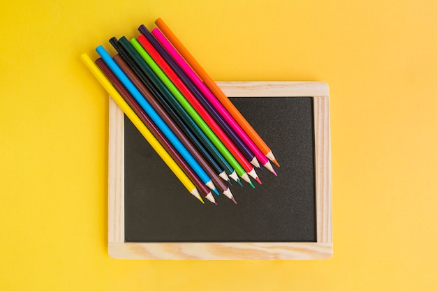 Pencils lying on blackboard