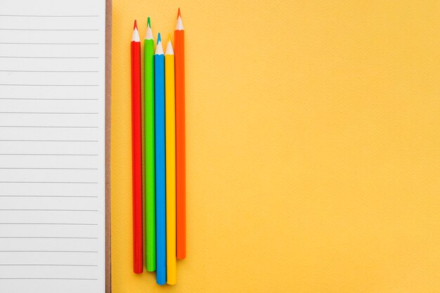 Pencils near lined paper