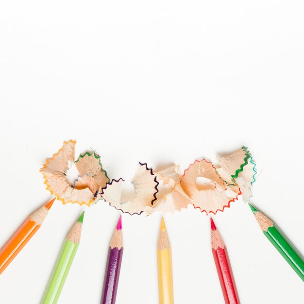 pencils and pencil shavings on white background