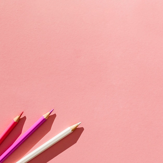 Free photo pencils on pink background arrangement