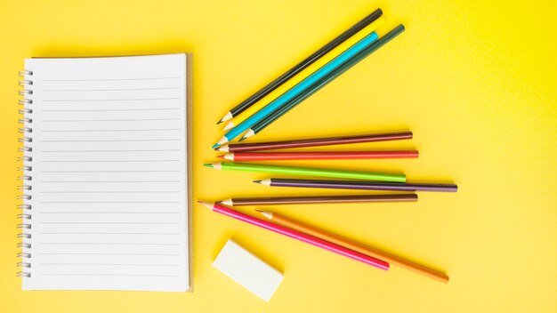 Pencils and rubber near notebook