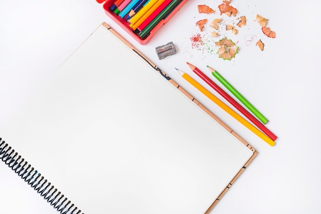 Pencils and sharpener near notebook