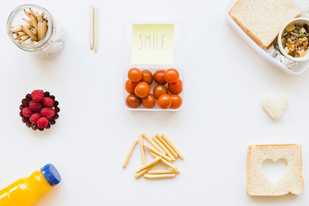 Pencils and sticky note near assorted food