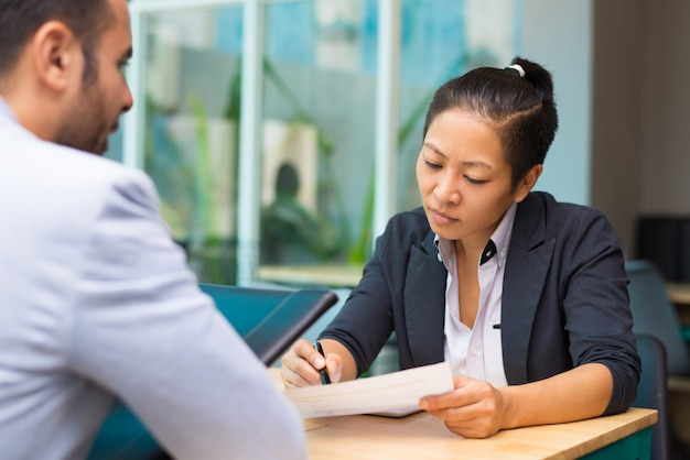 Pensive Asian executive manager meeting with job applicant