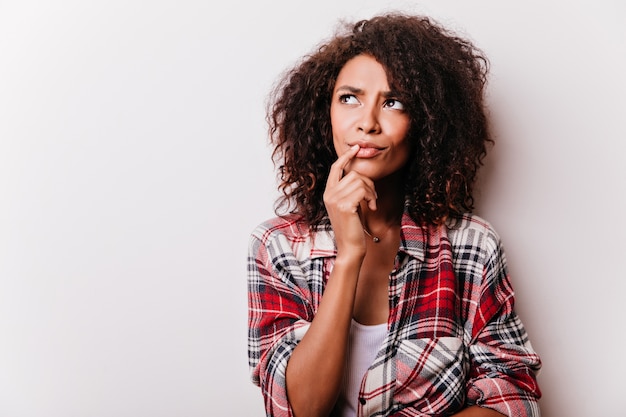 Pensive beautiful black woman looking up. portrait of serious brunette female model.