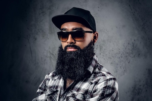 Portrait of man with grey beard wearing spectacles and hat stock photo