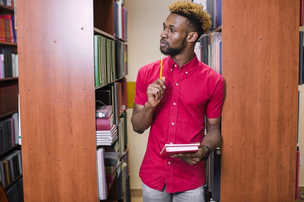 Pensive black man in library