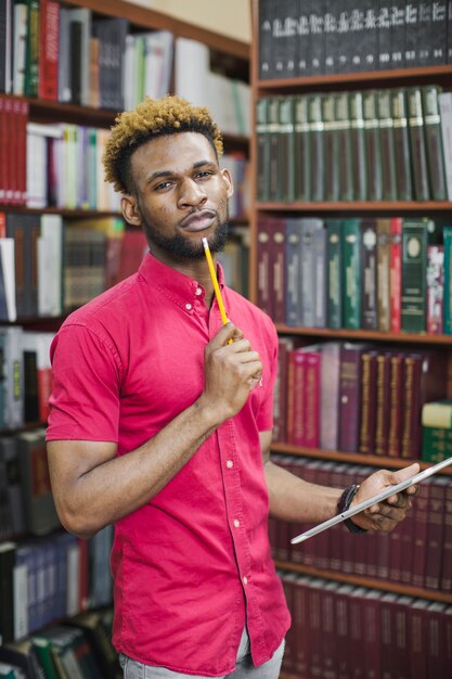 Pensive black man with pencil