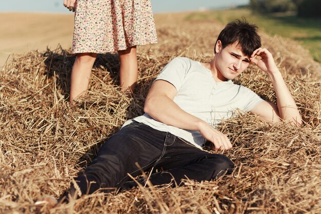 Pensive boy lying on straw