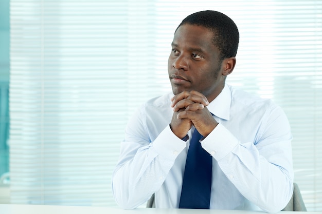 Pensive businessman sitting in his office