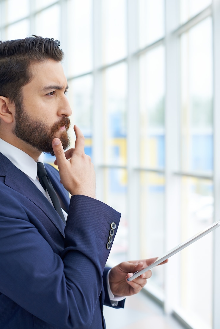 Free Photo pensive businessman staring through the window
