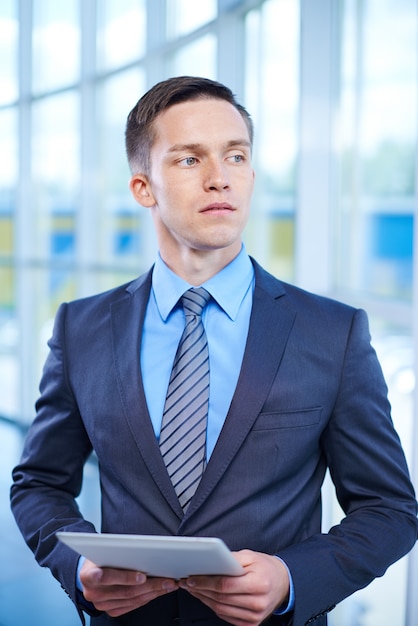 Pensive businessman with a document