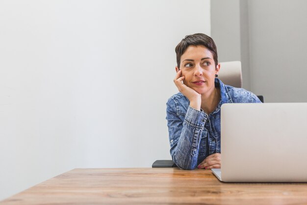 Pensive businesswoman with a hand on her cheek