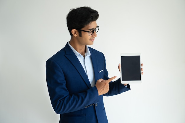 Pensive confident advisor showing digital tablet while presenting information.