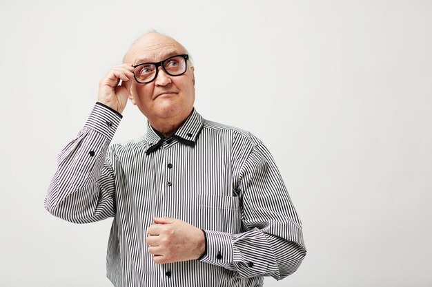 Pensive elderly man in glasses