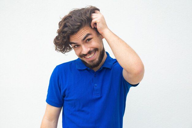 Pensive embarrassed guy scratching head, feeling guilty