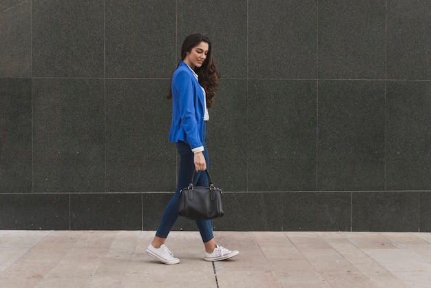 Pensive employee walking down the street