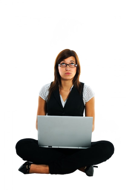 Free photo pensive employee working with laptop