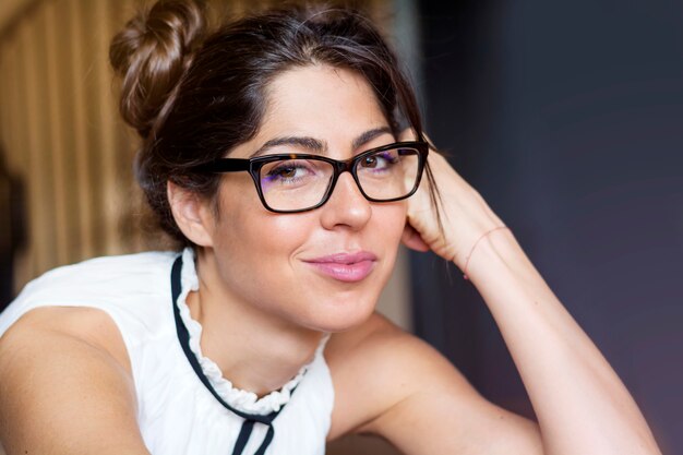 Pensive girl with black glasses