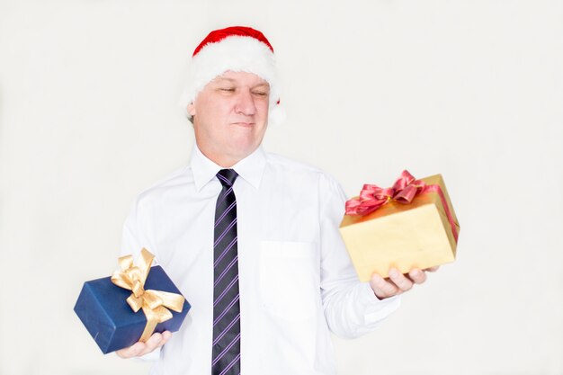 Pensive grimacing businessman choosing gift