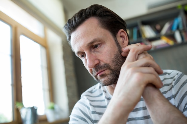 Pensive man sitting in coffee shop