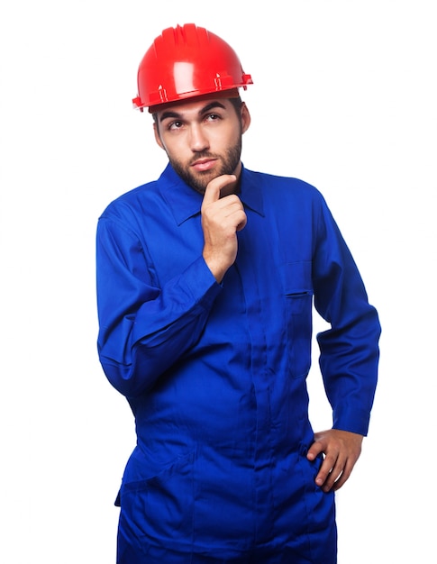  pensive man with a blue jumpsuit and a red helmet