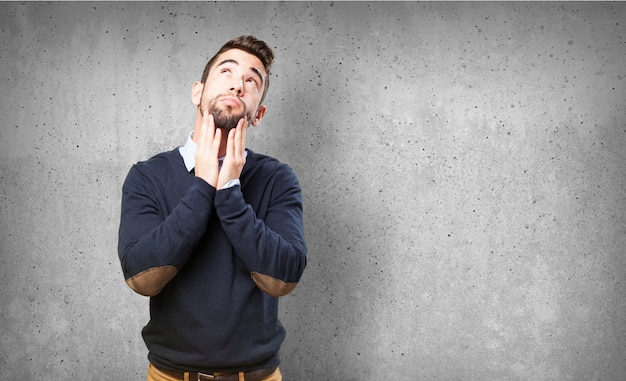 Free photo pensive man with hands on chin