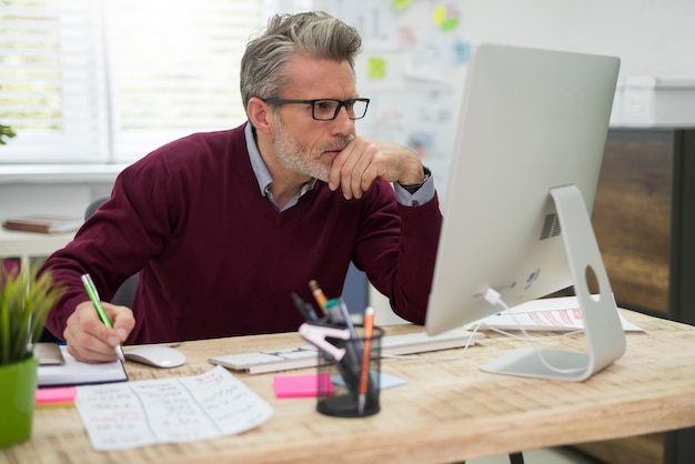 Pensive man working hard on computer