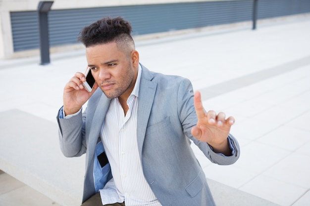 Pensive manager talking to client on phone