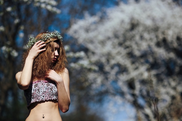 Pensive red-haired woman outdoors