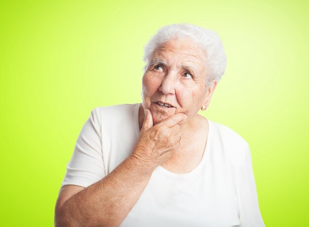 Pensive senior woman with a hand on chin