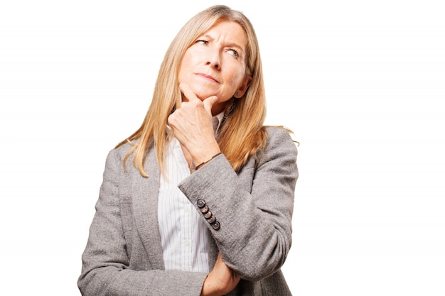 Free photo pensive senior woman with hand on chin