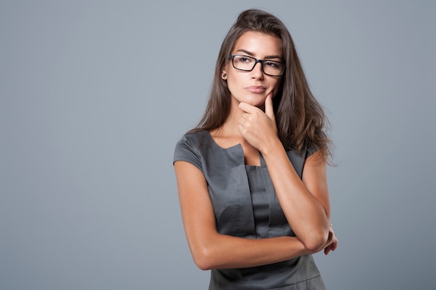 Pensive and thoughtful young businesswoman