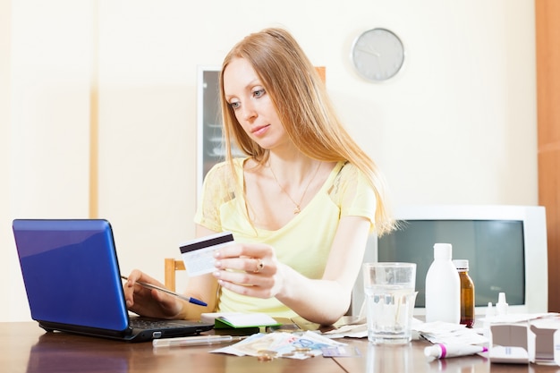 Free photo pensive woman buying medication online