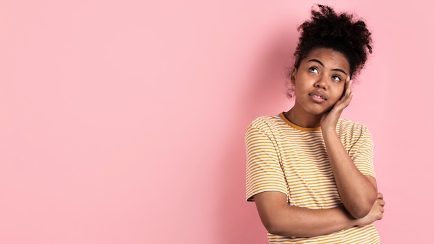 Pensive woman posing with hand on face