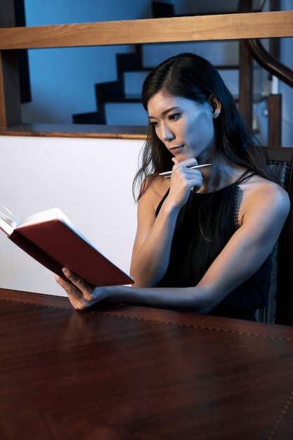 Pensive woman reading diary