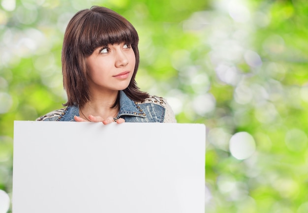 Pensive woman with a blank board