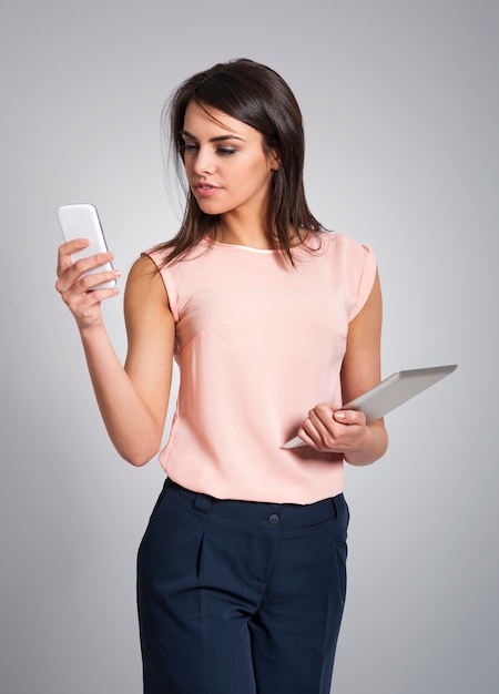 Pensive woman with electronic equipment