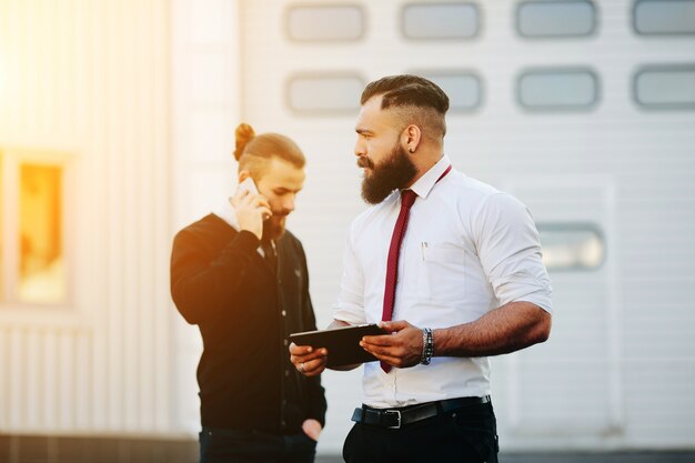 Pensive worker holding a tablet