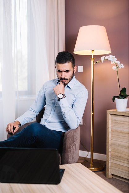 Pensive worker at laptop