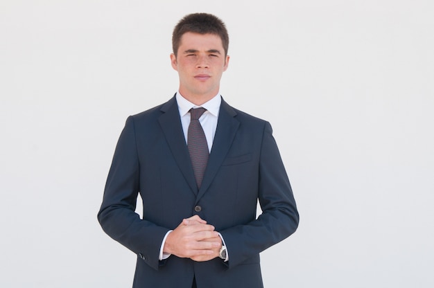 Free photo pensive young business consultant standing for camera