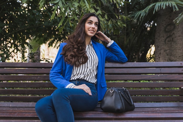 Free photo pensive young businesswoman resting in the park