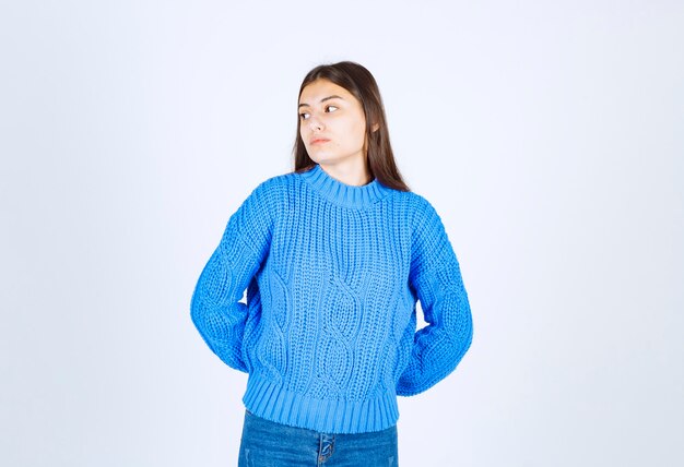 pensive young girl model standing and looking away .