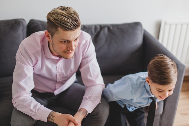 Free photo pensive young man next to his son