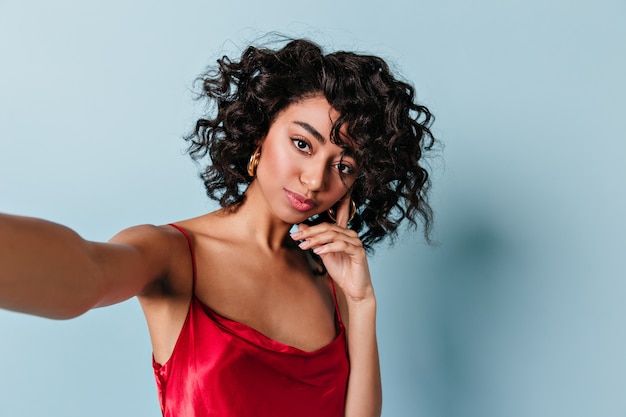 Pensive young woman taking selfie