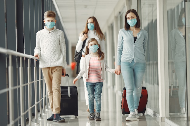 Люди в аэропорту носят маски, чтобы защитить себя от вируса