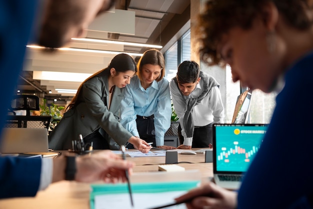 Free photo people analyzing and checking finance graphs in the office