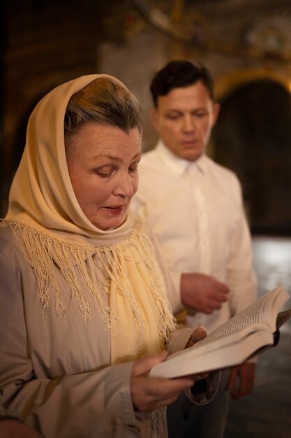 People attending sermon in church in celebration of greek easter