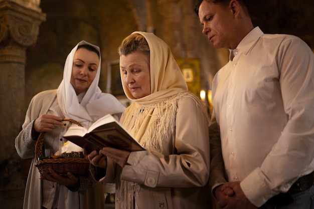 People attending sermon in church in celebration of greek easter